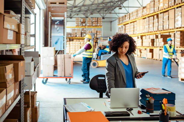 Close up of a warehouse manager using a laptop